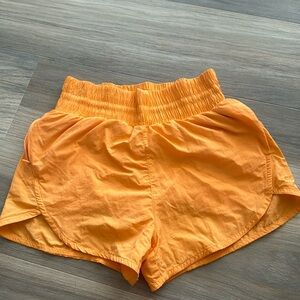All in Motion bright orange shorts.